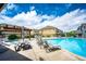 Community pool area featuring comfortable lounge chairs, picnic table, and a refreshing swimming pool at 15955 E Geddes Dr # 55, Aurora, CO 80016