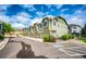 Modern townhome exteriors showcase attached garages and manicured greenery, set beneath a sunny blue sky at 15955 E Geddes Dr # 55, Aurora, CO 80016