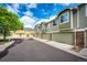 View of townhomes with attached garages, showcasing stone accents and well-maintained landscaping at 15955 E Geddes Dr # 55, Aurora, CO 80016