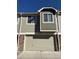 Attached garage with brick accents and a wide driveway providing ample parking space for residents and guests at 15955 E Geddes Dr # 55, Aurora, CO 80016