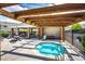 A pergola provides shade for a hot tub and picnic tables in this appealing outdoor common area at 15955 E Geddes Dr # 55, Aurora, CO 80016