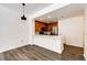 Charming kitchen with wood cabinetry, stainless appliances, and modern fixtures, open to living area at 15955 E Geddes Dr # 55, Aurora, CO 80016