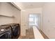 Convenient laundry area with modern washer and dryer units and adjacent shelved closet storage at 15955 E Geddes Dr # 55, Aurora, CO 80016