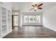 Spacious living room featuring three large windows and a modern ceiling fan at 15955 E Geddes Dr # 55, Aurora, CO 80016