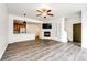 Bright living room with modern fireplace, built-ins, open to kitchen with sleek wood floors at 15955 E Geddes Dr # 55, Aurora, CO 80016