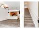 Open living space with staircase, modern lighting, and kitchen featuring wood cabinets at 15955 E Geddes Dr # 55, Aurora, CO 80016