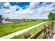 A long walkway passes by a playground and green space, perfect for outdoor recreation and Gathering fun at 15955 E Geddes Dr # 55, Aurora, CO 80016