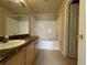 Bright bathroom featuring a tub with shower, vanity with granite countertop and updated fixtures at 4519 S Atchison Way, Aurora, CO 80015