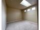 Bright bedroom featuring a skylight, neutral carpet and walls, and ample natural light at 4519 S Atchison Way, Aurora, CO 80015