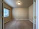 Cozy bedroom with neutral walls, plush carpet, and window with blinds, offering a comfortable and private retreat at 4519 S Atchison Way, Aurora, CO 80015