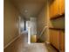 Hallway with carpeted floors leading to stairs and upper level, and cabinet for storage at 4519 S Atchison Way, Aurora, CO 80015