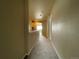 Carpeted hallway features access to additional rooms with a glimpse of natural light streaming through at 4519 S Atchison Way, Aurora, CO 80015