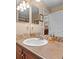 Neutral toned powder room with decorative mirror, tile backsplash, and single sink vanity at 1410 Exquisite St, Castle Rock, CO 80109