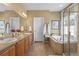 Spacious bathroom features double sinks, tub, walk-in shower, and tile floors at 1410 Exquisite St, Castle Rock, CO 80109