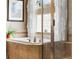 Close up on tub with glass shower enclosure and decorative accents at 1410 Exquisite St, Castle Rock, CO 80109