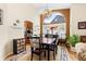 Elegant dining room with hardwood floors, chandelier, and large windows for ample light at 1410 Exquisite St, Castle Rock, CO 80109