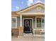 Charming home featuring a welcoming front door with decorative wreath and brick accents at 1410 Exquisite St, Castle Rock, CO 80109