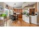 Bright kitchen and breakfast nook featuring hardwood floors, wooden cabinets and modern appliances at 1410 Exquisite St, Castle Rock, CO 80109