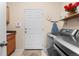 Laundry room featuring a washer and dryer and storage, enhanced by natural lighting at 1410 Exquisite St, Castle Rock, CO 80109