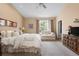 Inviting main bedroom suite with decorative furnishings, sitting area and bright windows at 1410 Exquisite St, Castle Rock, CO 80109