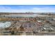 An aerial view of a shopping area near a lake, with a city skyline in the background at 2020 Gray St, Edgewater, CO 80214