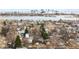 An aerial view of a neighborhood near a lake, with a city skyline in the background at 2020 Gray St, Edgewater, CO 80214