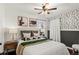 Cozy bedroom with accent wallpaper, ceiling fan, and a well-dressed bed with decorative pillows at 2020 Gray St, Edgewater, CO 80214