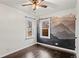 Cozy bedroom with mountain mural, hardwood floors and updated ceiling fan at 2020 Gray St, Edgewater, CO 80214