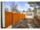 Long driveway leading to a detached garage, bordered by a wooden fence at 2020 Gray St, Edgewater, CO 80214