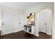 Bright entryway featuring modern décor, stylish storage cabinet and arched doorway to bedroom at 2020 Gray St, Edgewater, CO 80214