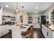 Newly remodeled kitchen featuring pendant lighting, a large island, and modern appliances at 2020 Gray St, Edgewater, CO 80214