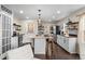 Modern kitchen with island, white cabinets, stainless steel appliances and farmhouse sink at 2020 Gray St, Edgewater, CO 80214