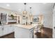 Well-lit kitchen flows to living area, showcasing modern pendant lights at 2020 Gray St, Edgewater, CO 80214