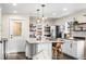 Spacious kitchen with island, pendant lights, seating, and stainless steel appliances at 2020 Gray St, Edgewater, CO 80214