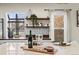 Close up of kitchen island with seating, decor, and a view of the backyard at 2020 Gray St, Edgewater, CO 80214