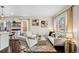 Sunlit living room and kitchen area with modern furnishings and dark hardwood floors at 2020 Gray St, Edgewater, CO 80214