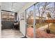 Inviting sunroom with brick accent wall, leading to a well-maintained backyard at 2020 Gray St, Edgewater, CO 80214