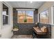 Bright sunroom featuring a functional workspace with a desk and ample natural light at 2020 Gray St, Edgewater, CO 80214