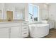 Luxurious bathroom featuring a soaking tub and double sinks at 13905 Emerald Lake St, Parker, CO 80138