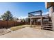 Spacious backyard featuring concrete patio and wooden deck, perfect for outdoor activities and relaxation at 11404 E Yale Pl, Aurora, CO 80014