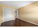 Bedroom featuring hardwood floors, closet and neutral paint at 11404 E Yale Pl, Aurora, CO 80014