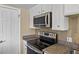 Close-up of kitchen area features stainless steel appliances and granite countertops at 11404 E Yale Pl, Aurora, CO 80014