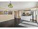 Bright kitchen with modern appliances, island, and dark wood floors at 11404 E Yale Pl, Aurora, CO 80014