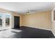 Living room with wood paneled walls, glass patio doors and dark floors at 11404 E Yale Pl, Aurora, CO 80014