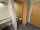 View of half bathroom featuring tiled floors, granite countertops, and wood cabinets at 1401 Wewatta St # 714, Denver, CO 80202