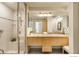 Bright bathroom featuring tiled shower, double sinks, and granite countertops at 1401 Wewatta St # 714, Denver, CO 80202