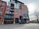 Modern brick apartment building with a garage and parking at 1401 Wewatta St # 714, Denver, CO 80202