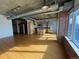 Spacious living room featuring bamboo floors, exposed ductwork, and brick accent walls, with natural light and a modern touch at 1401 Wewatta St # 714, Denver, CO 80202