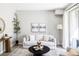 Bright living room featuring modern furnishings, a stylish rug, and plenty of natural light at 5036 S Platte River Pkwy, Littleton, CO 80123