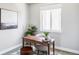 Bright home office features neutral decor, a classic desk, and natural light at 5036 S Platte River Pkwy, Littleton, CO 80123